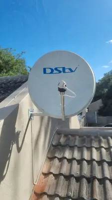 DStv satellite dish wall mounted on residential home